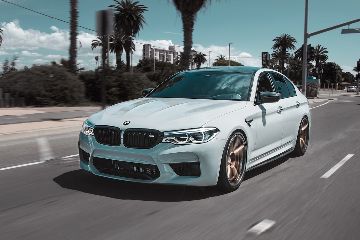 background image of a BMW on a forest road